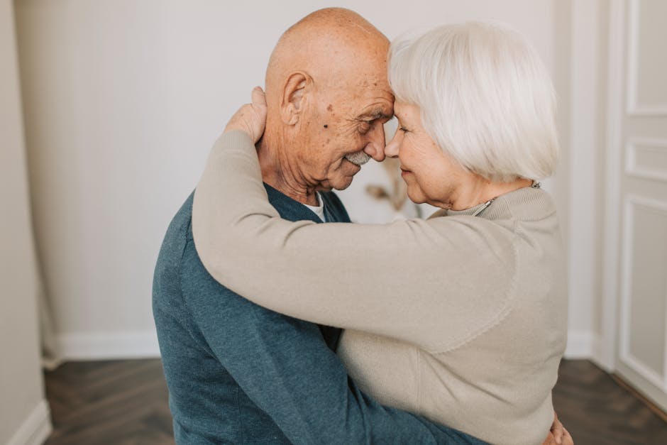 Senior couple sharing a tender embrace indoors, showcasing love and connection.