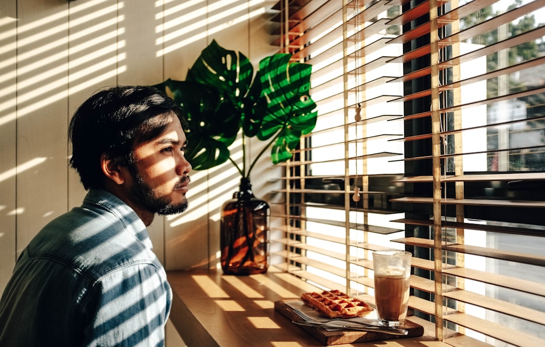 a person sitting at a table with food and drinks