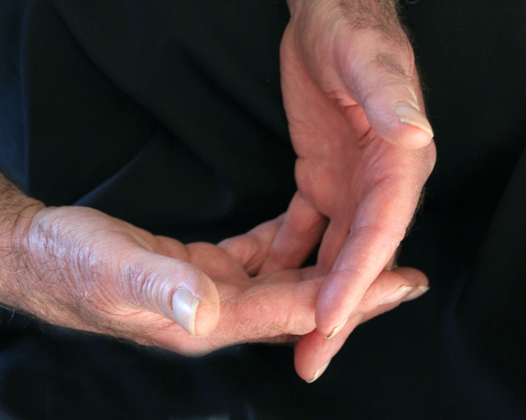 a close up of a person holding their hands together