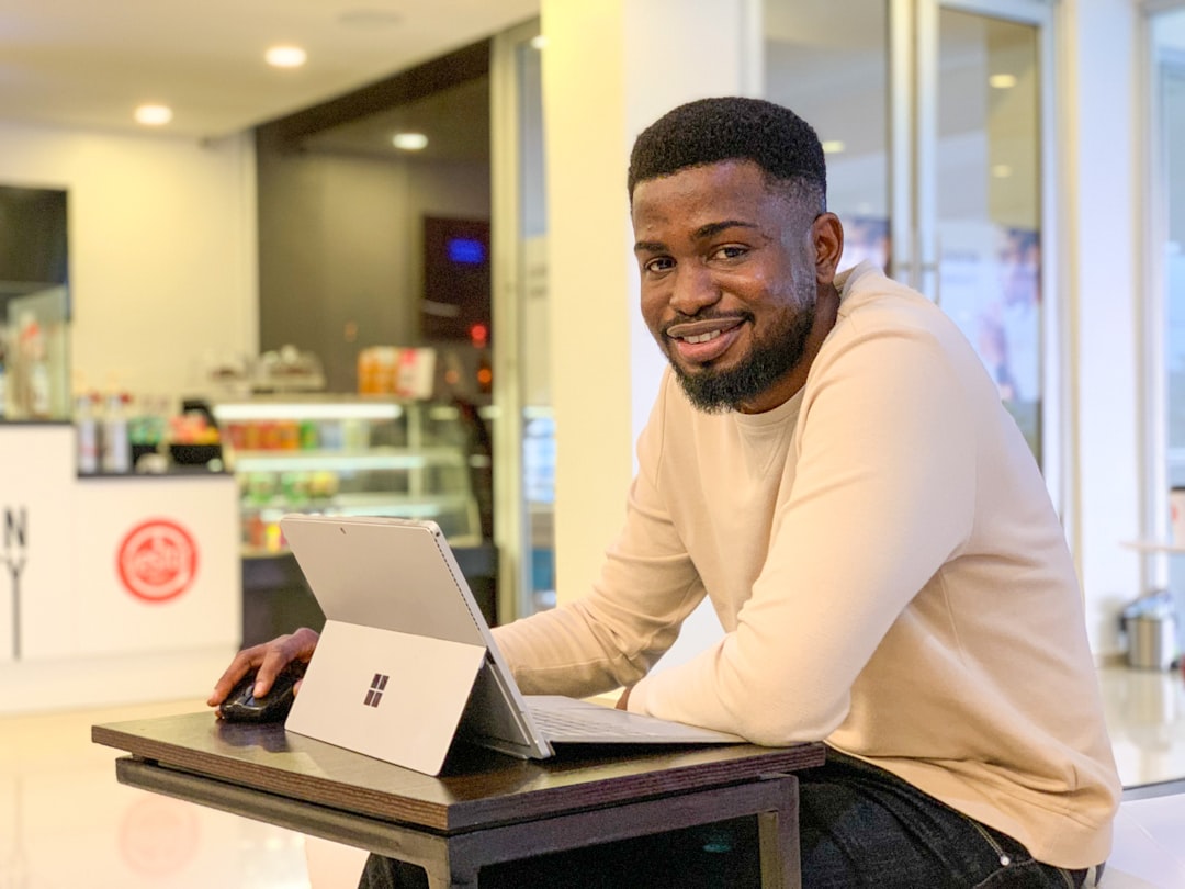 a man sitting at a table with a laptop
