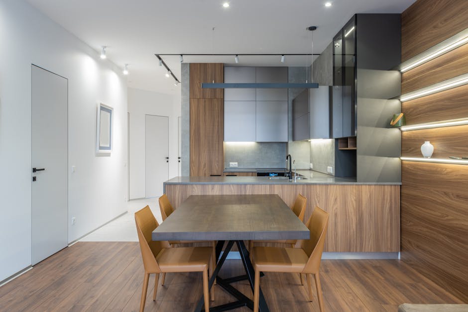 Stylish modern kitchen and dining space with wooden elements and sleek design.