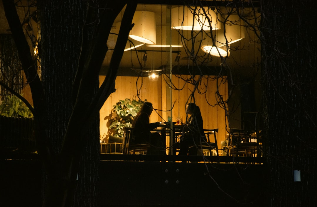Two people sitting at a table at night.