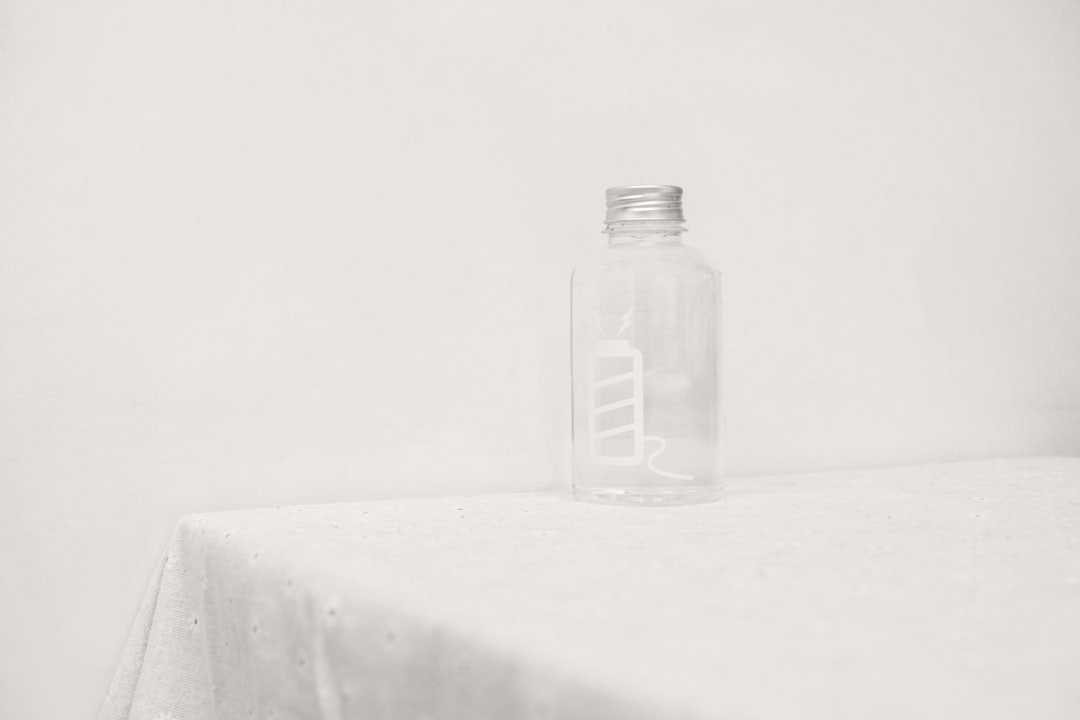 a glass bottle sitting on top of a table