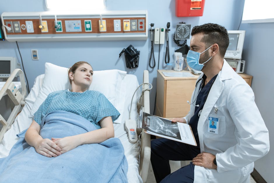 A medical practitioner discusses health details with a patient in a hospital setting.