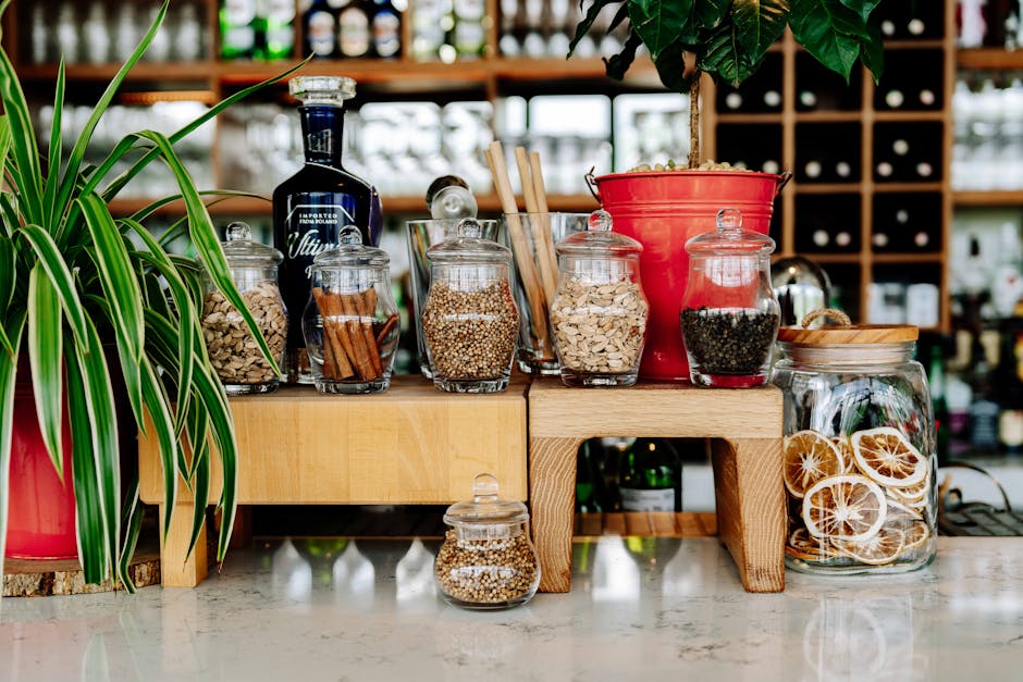 A vibrant assortment of spices and herbs elegantly arranged in glass jars at a market in Arusha, Tanzania.