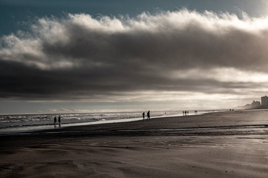 couple walking happily on beach at sunset