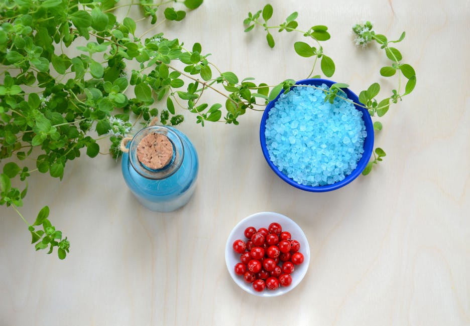 Colorful arrangement of blue salt, red berries, and marjoram for a refreshing still life display.
